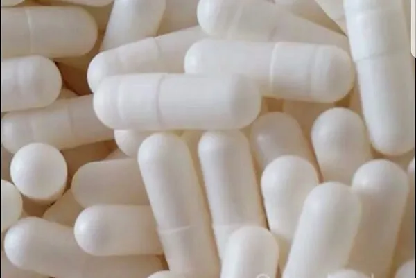 White capsules piled closely together.